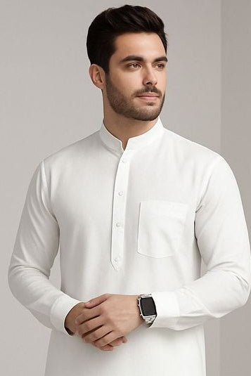 Man wearing a white traditional kurta against a plain background
